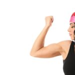 a woman with her fist raised, showing muscle, a feminist symbol of struggle and strength