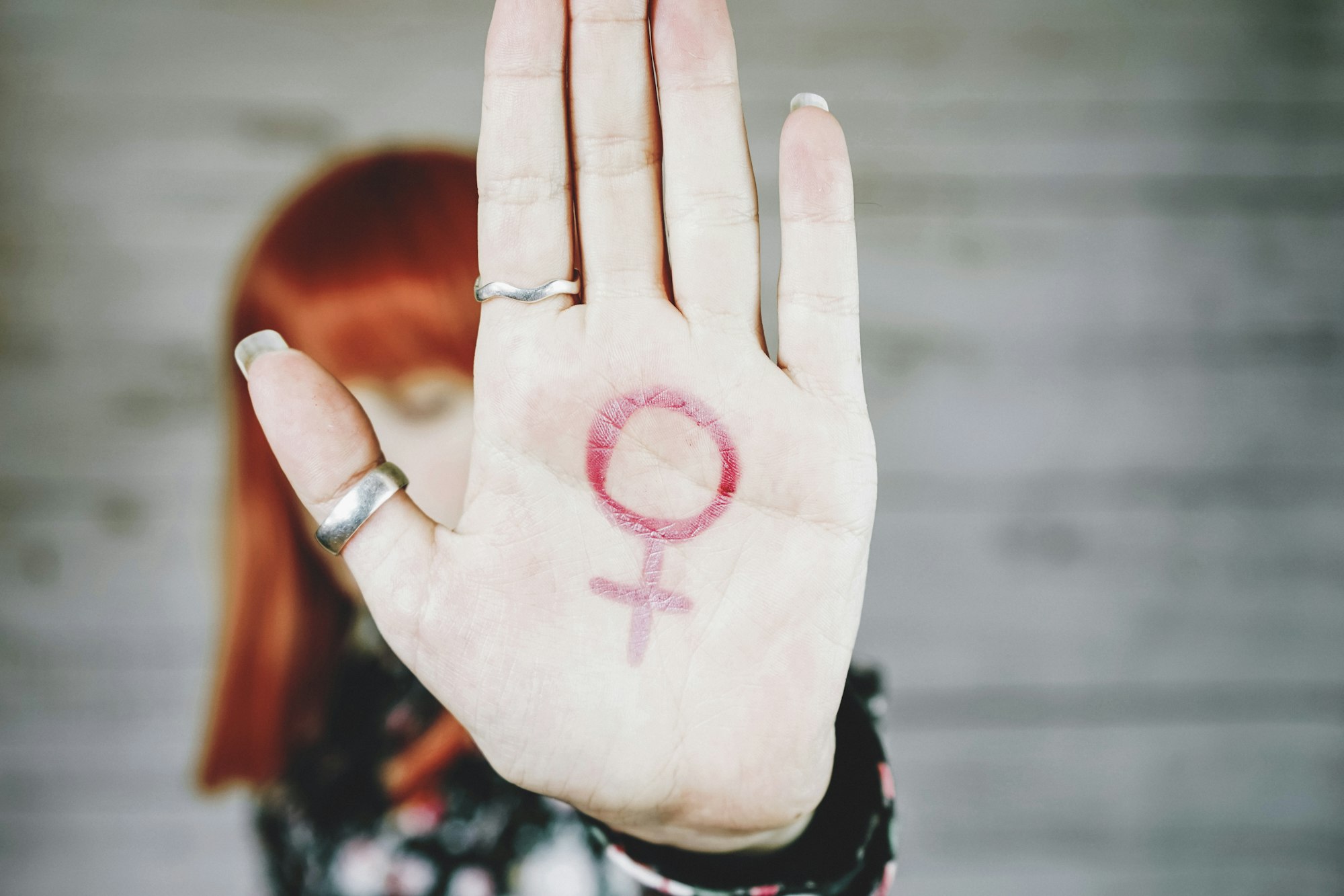 Young feminist with a female sign in her hand